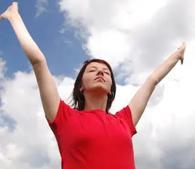 A woman with her arms raised in the air.