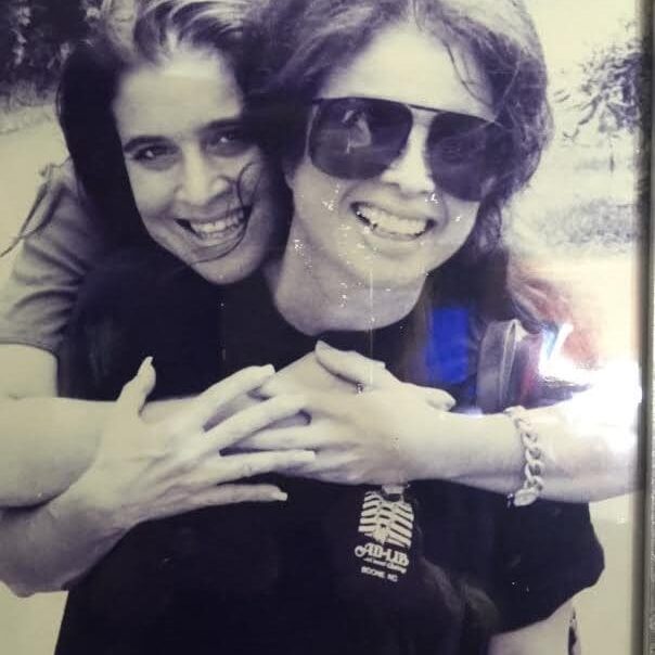 Two women hugging, black and white photo.